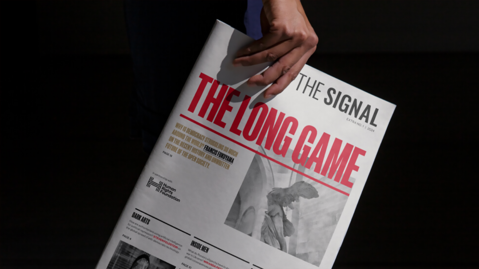 HRF x The Signal "The Long Game" newspaper with black background