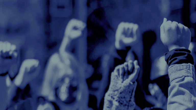 HRF Op-ed header featuring numerous fists raised in protest and solidarity