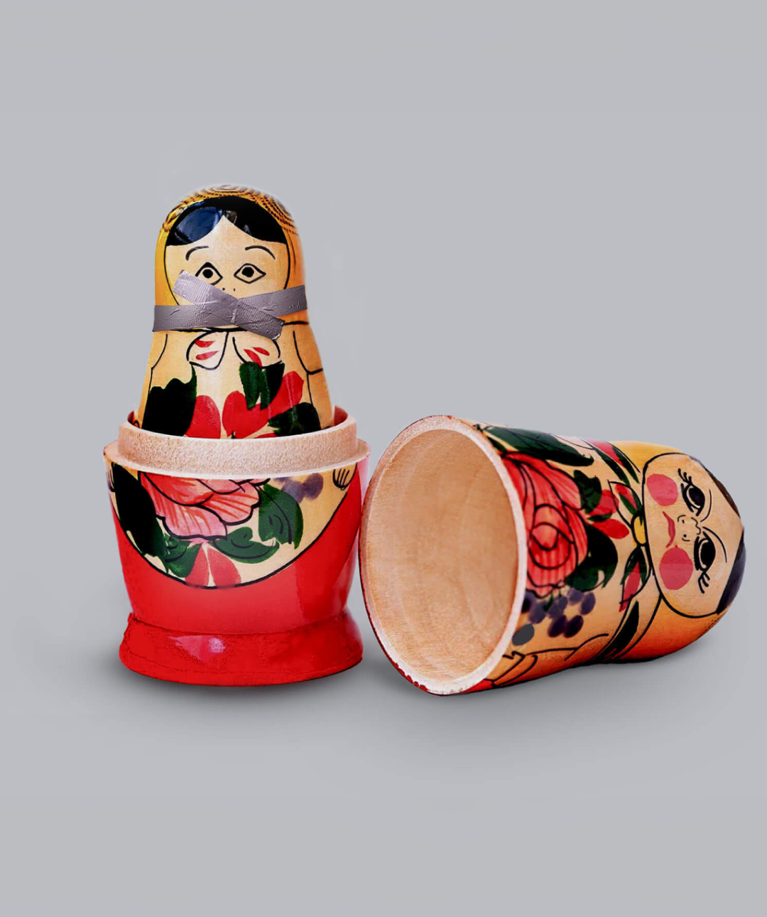 Russian dolls. One standing, one knocked over.