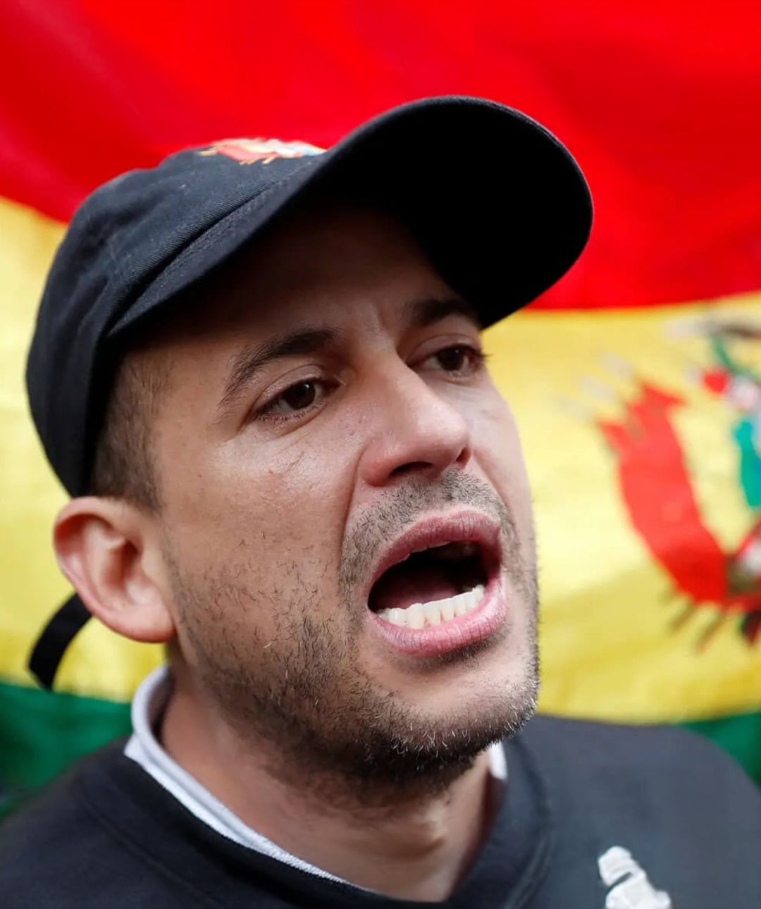 Bolivian activist with the Bolivian flag in the background