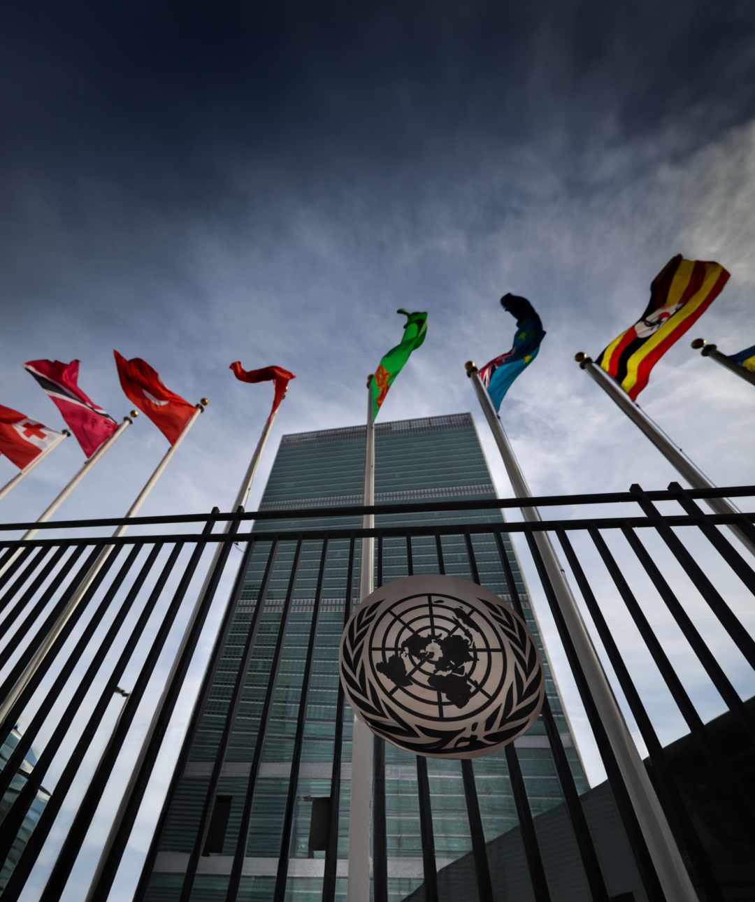 Photo of United Nations headquarters in New York displaying waving flags