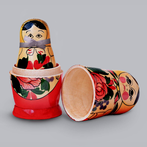 Russian dolls. One standing, one knocked over.