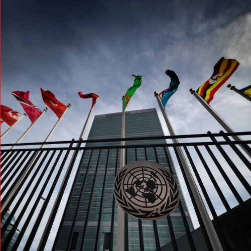 Photo of United Nations headquarters in New York displaying waving flags