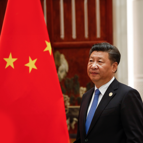 Photo of Chinese president Xi Jinping standing in front of Chinese flag