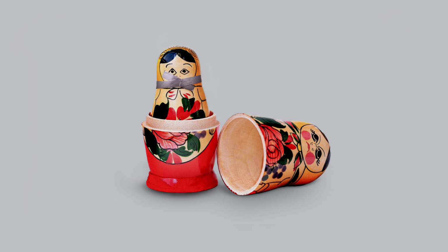 Russian dolls. One standing, one knocked over.