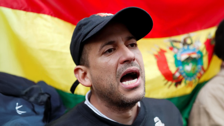 Bolivian activist with the Bolivian flag in the background