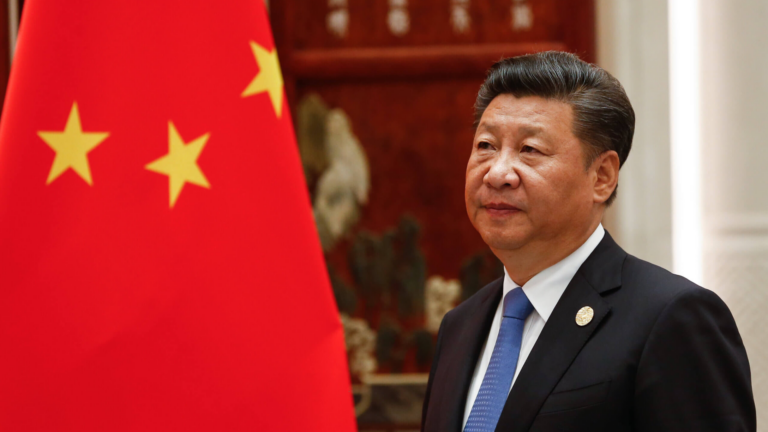 Photo of Chinese president Xi Jinping standing in front of Chinese flag