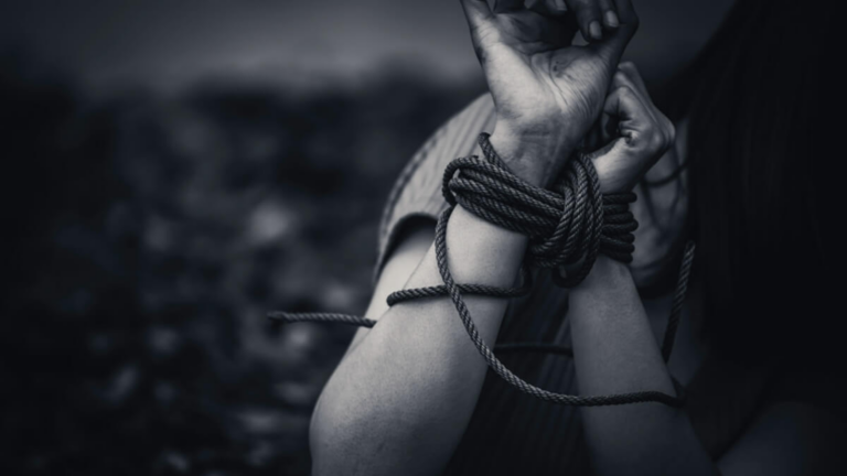 Hands tied together by a rope with a ominent black and white shade