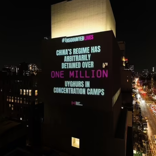 Dramatic projections beamed onto buildings during New York Fashion Week shame clothing industry for using Uyghur forced labor - Thumbnail