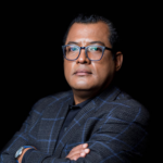 Felix Maradiaga headshot with black background