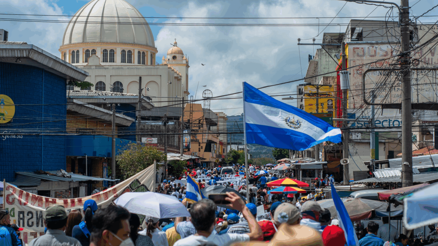 El Salvador flag waving in crowd of people in the nations capital