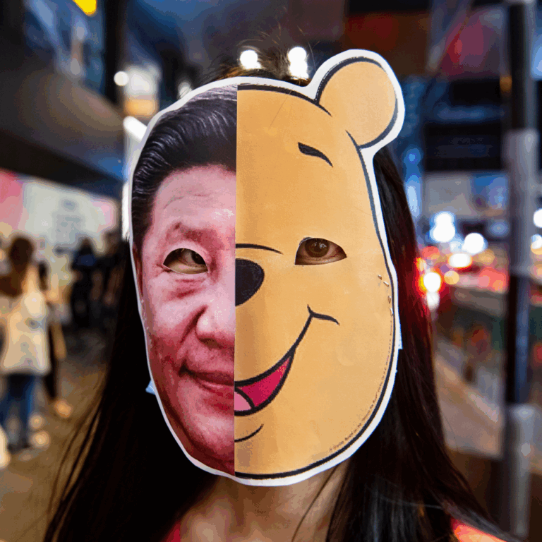 Youthquake Report - A protester wears a mask with a split image of Xi Jinping and Winnie the Pooh, a satiricization of the Chinese ruler