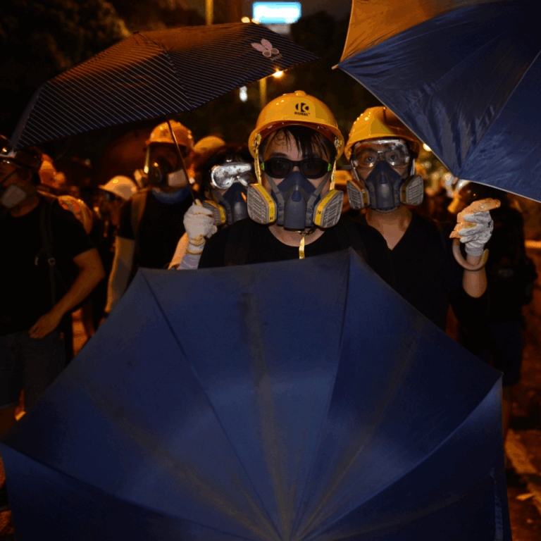 Youthquake Report - Protesters wear gas masks, yellow helmets, sunglasses, and other protective gear on their way to a demonstration